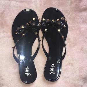 Black sandals with gold studded bow